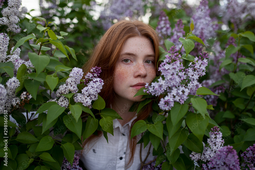 Portrait of teenage girl standing among flowers Portrait of teenage girl standing among flowers