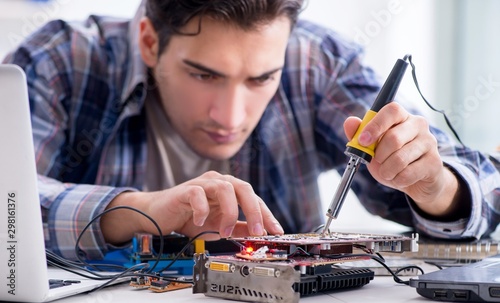 The professional repairman repairing computer in workshop