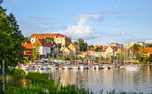 View of the center of Ryn, the castle, the lake and the marina with moored boats. Masuria, Poland. photo