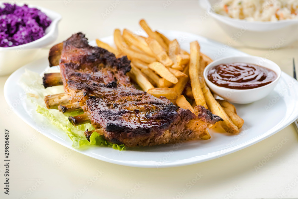 baked ribs and French fries and cabbage salad baked ribs and French fries and cabbage salad