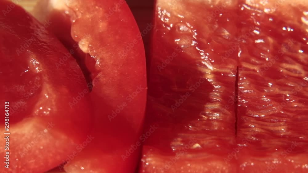 Sliced red bell pepper. 4K resolution macro trucking shot. Sliced red bell pepper. 4K resolution macro trucking shot.