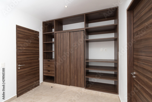 brown closet inside a white bedroom