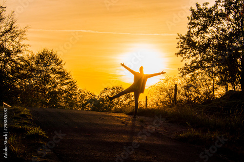 Female enjoys the sunlight of warm autumn