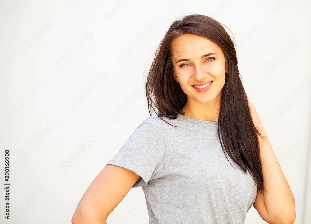 Happy brunette woman in gray t-shirt Happy brunette woman in gray t-shirt