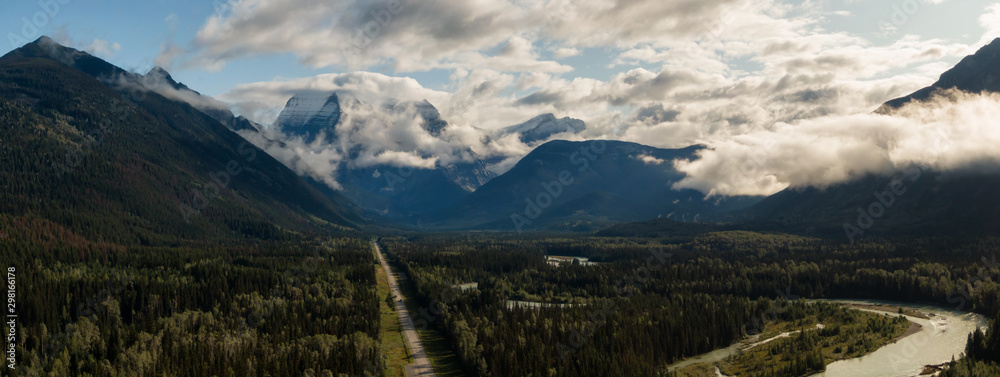 Aerial Panoramic View of Scenic Road in the Beautiful Canadian Mountain Landscape during a sunny and cloudy summer sunrise. Taken near Mt Robson, British Columbia, Canada.