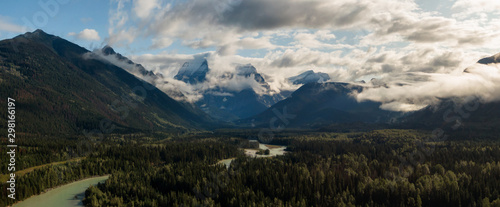 Aerial Panoramic View of Beautiful Canadian Mountain Landscape during a sunny and cloudy summer sunrise. Taken near Mt Robson, British Columbia, Canada.