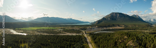 Aerial Panoramic View of Small Town, Canal Flats, during a sunny and cloudy summer day. Located in the Kootenay, British Columbia, Canada.