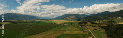 Aerial Panoramic View of Small Town, Creston, during a sunny and cloudy summer day. Located in the Interior of British Columbia, Canada. © edb3_16
