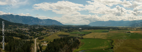 Aerial Panoramic View of Small Town, Creston, during a sunny and cloudy summer day. Located in the Interior of British Columbia, Canada. photo