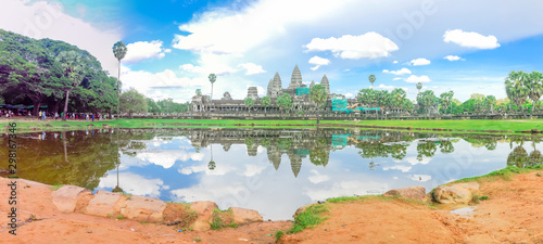 Panoramic view Angkor Wat facade under construction and palm tree reflection on the lake © trongnguyen