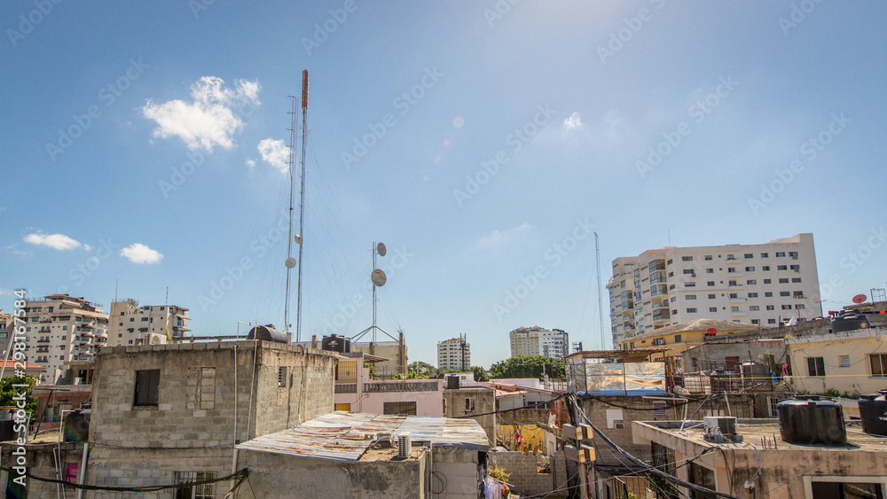 Fototapeta premium View of The Roofs of Some Poor Houses, There is Much Chaos by the Wires of Electric Poles