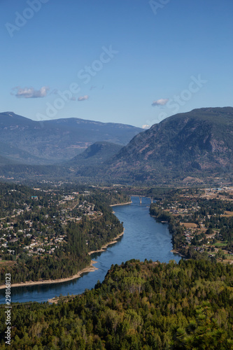 Aerial View of a small town, Castlegar, during a sunny summer day. Located in Central Kootenay, British Columbia, Canada.