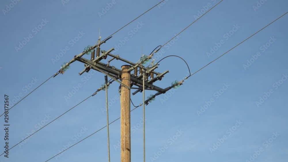 View to electrical distribution fuses structure. The design of the voltage-current line in a close-up on a blue sky background. Power supply pole.