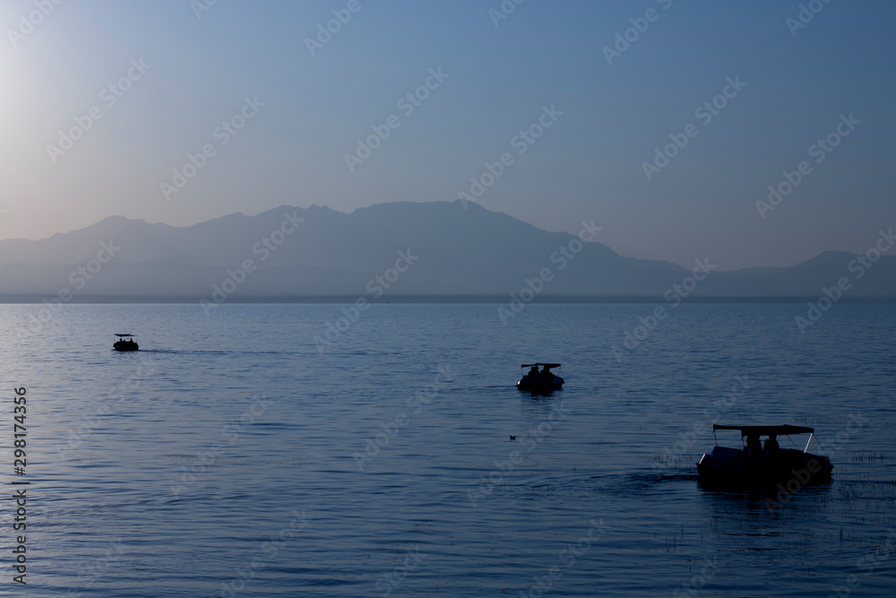 Touring boats at sunset