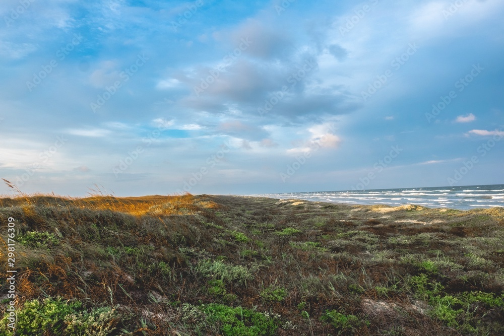 Sunrise and sunset along the dunes of Mustang Island on the Texas Coast Sunrise and sunset along the dunes of Mustang Island on the Texas Coast