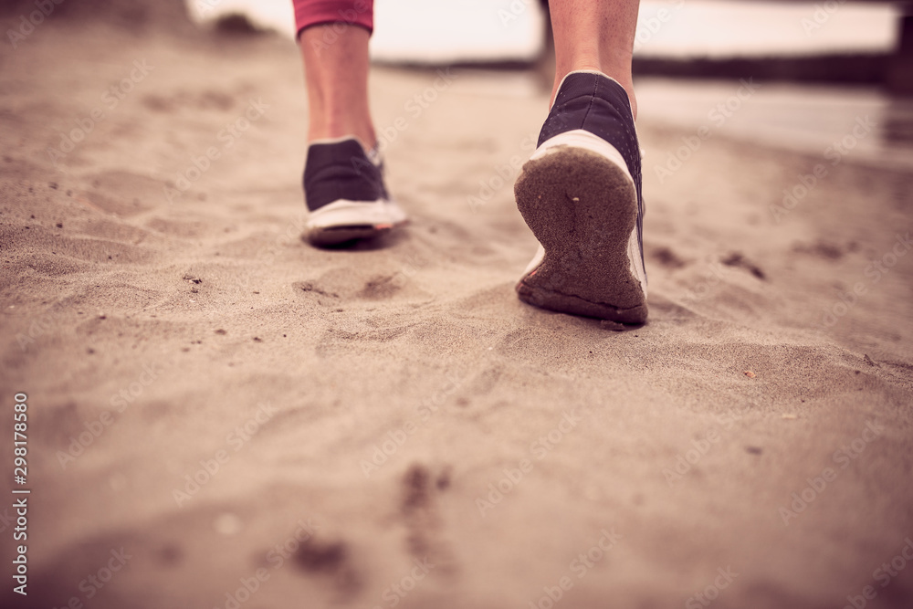 Female running feet in sport shoes