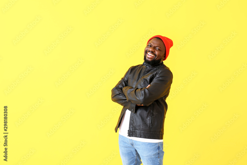 Portrait of happy African-American man on color background