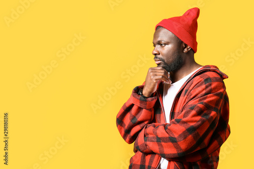 Portrait of handsome African-American man on color background © Pixel-Shot