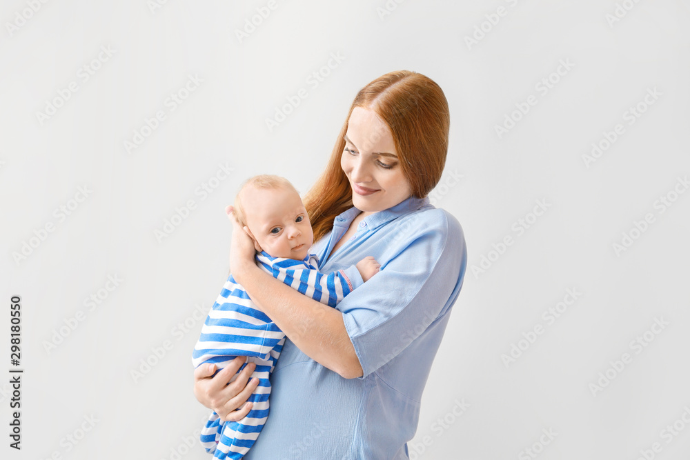 Mother with cute baby on light background Mother with cute baby on light background