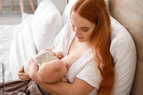 Young woman breastfeeding h...