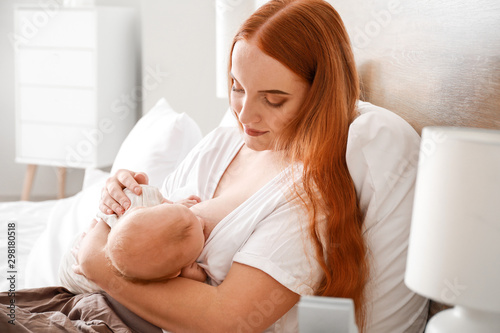 Young woman breastfeeding h...