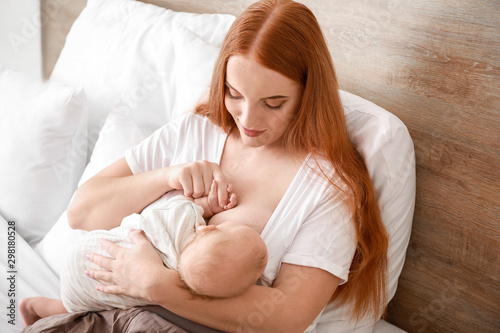 Young woman breastfeeding h...