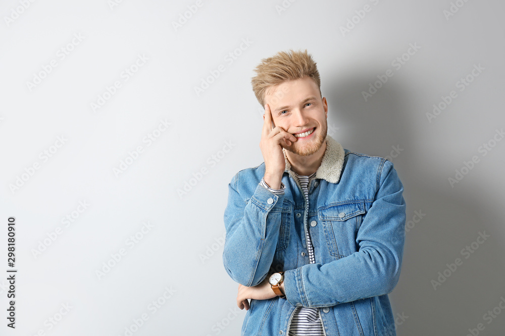 Portrait of stylish young man on light background Portrait of stylish young man on light background