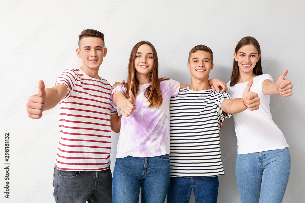 Cool teenagers showing thumb-up on white background Cool teenagers showing thumb-up on white background