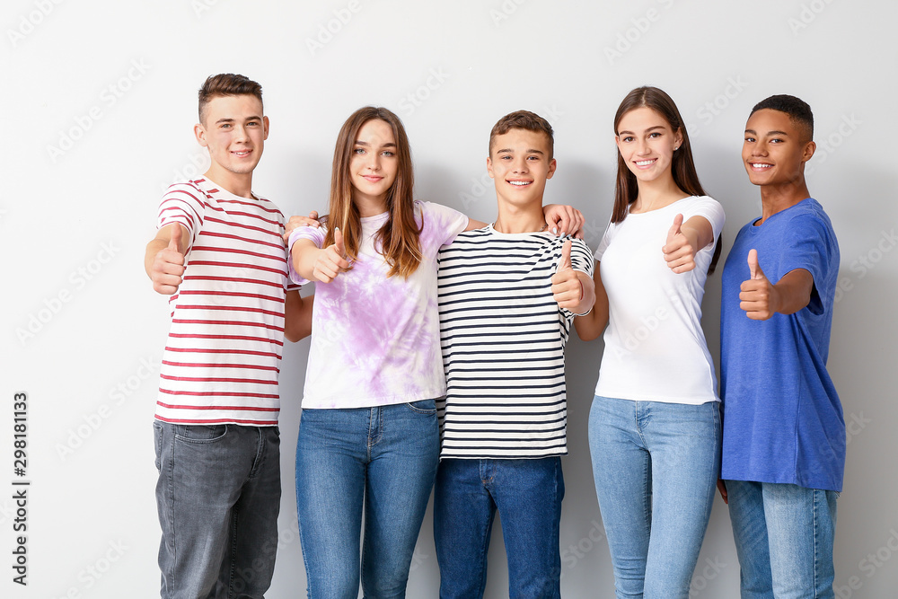 Cool teenagers showing thumb-up on white background Cool teenagers showing thumb-up on white background