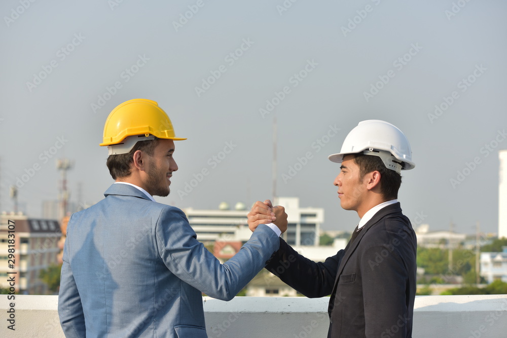 Business concept Engineers and technicians agree to work together to push. Business concept Engineers and technicians agree to work together to push.