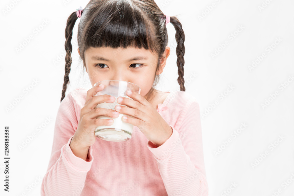 Little girls are drinking fresh milk in glass for health. Little girls are drinking fresh milk in glass for health.