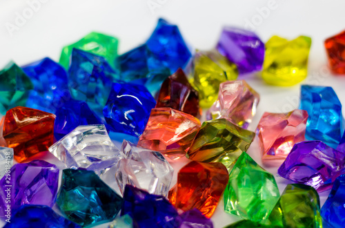 Multi-colored stones on a white background. Plastic accessories.