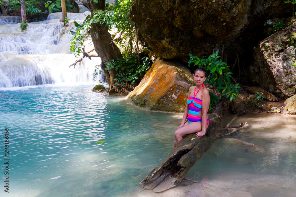 Fototapeta premium Woman in bikini beautiful happy with waterfall