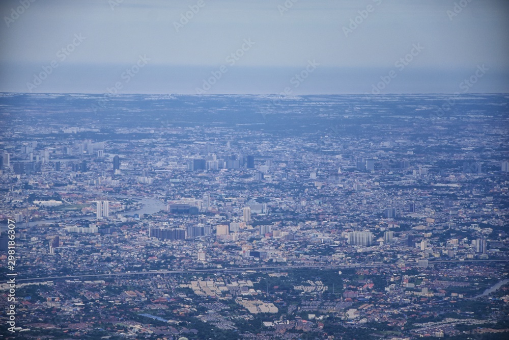 Fototapeta premium Aerial view of Bangkok Thailand and surrounding landscape, modern office buildings, condominium, living place in Bangkok city downtown in the most populated. Southeast Asia.