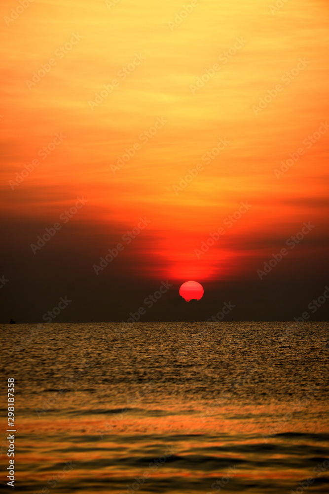 The rising sun view and the beach. Beautiful golden yellow sky and sun The view of the beach, the beach and the sun loungers are rising. The rising sun view and the beach. Beautiful golden yellow sky and sun The view of the beach, the beach and the sun loungers are rising.