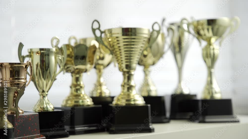 group of golden trophies by the window