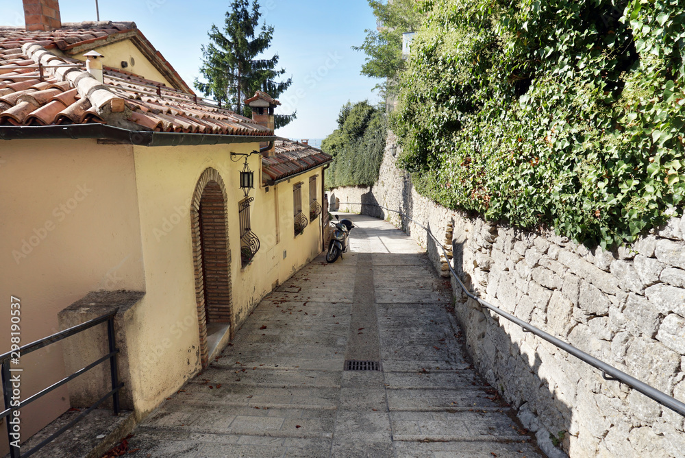 Narrow paved street with old houses in the old district of the San Marino city
