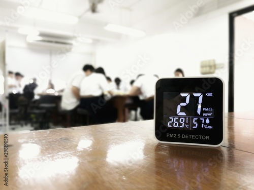 measuring indoor air quality. PM 2.5 (particulate matter) small dust particle pollution detector found higher than acceptable standard of dust in a classroom with students. harmful indoor environment
