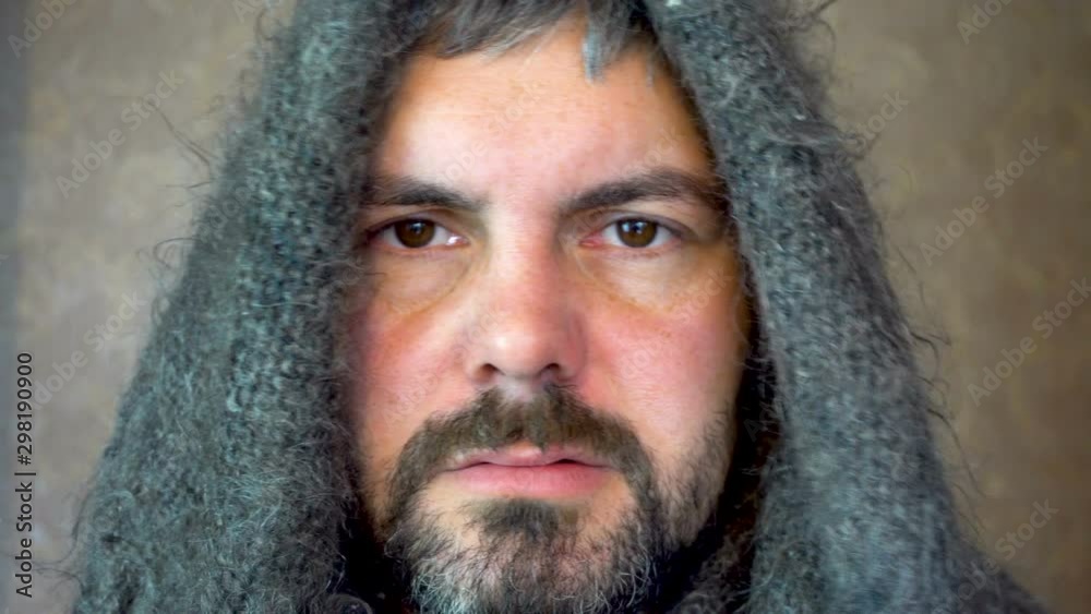 Bearded man in a warm scarf. Sick look of man. Allergic reaction. Dark eyes. Short haircut. Close-up. Bearded man in a warm scarf. Sick look of man. Allergic reaction. Dark eyes. Short haircut. Close-up.