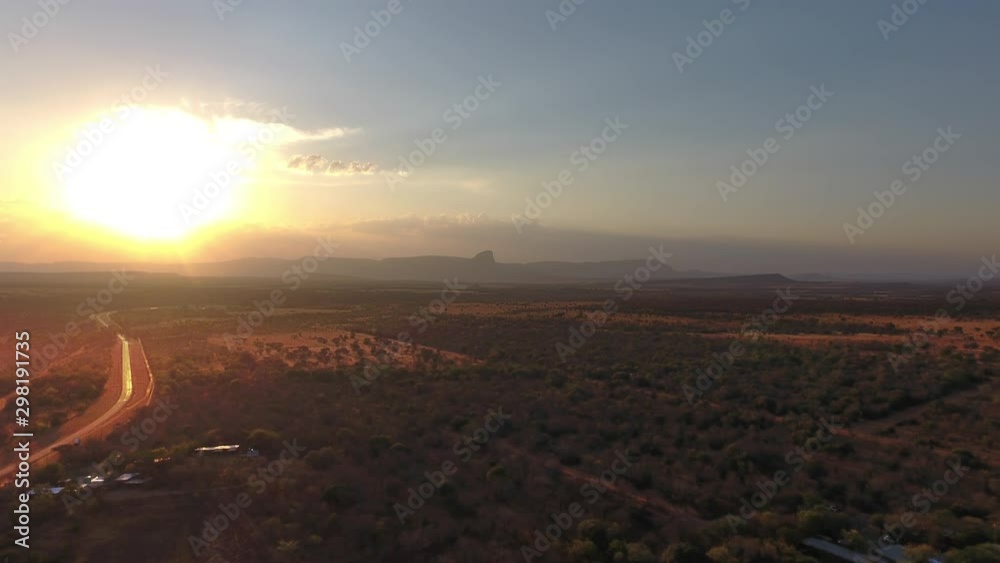 Explosion of light as the sun sets behind cloud & Hanglip mountain in Sterkrivier South Africa. Beautiful country side road on the left driving into the sunset. Explosion of light as the sun sets behind cloud & Hanglip mountain in Sterkrivier South Africa. Beautiful country side road on the left driving into the sunset.