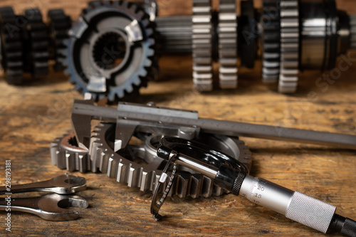 motorcycle gearbox/transmission on a workbench with precision measuring tools