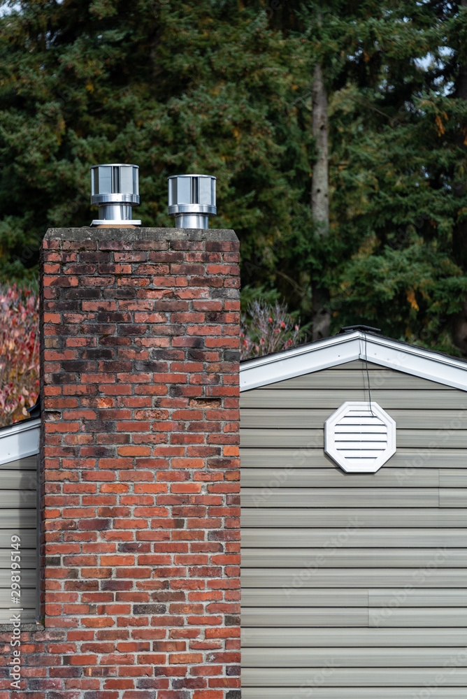 Exterior wall of suburban house, old brick chimney with chimney vents, attic  fan exhaust vent on wall Stock-Foto | Adobe Stock