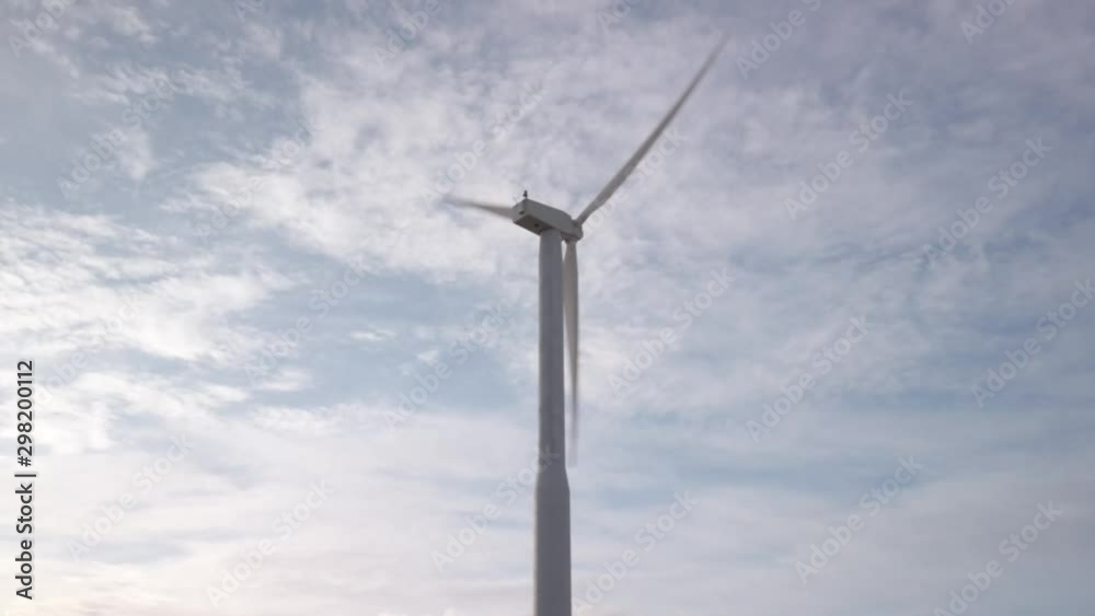 Environmentally friendly wind farm creating renewable sourced electricity, early morning sunrise, high clouds, windy conditions Environmentally friendly wind farm creating renewable sourced electricity, early morning sunrise, high clouds, windy conditions