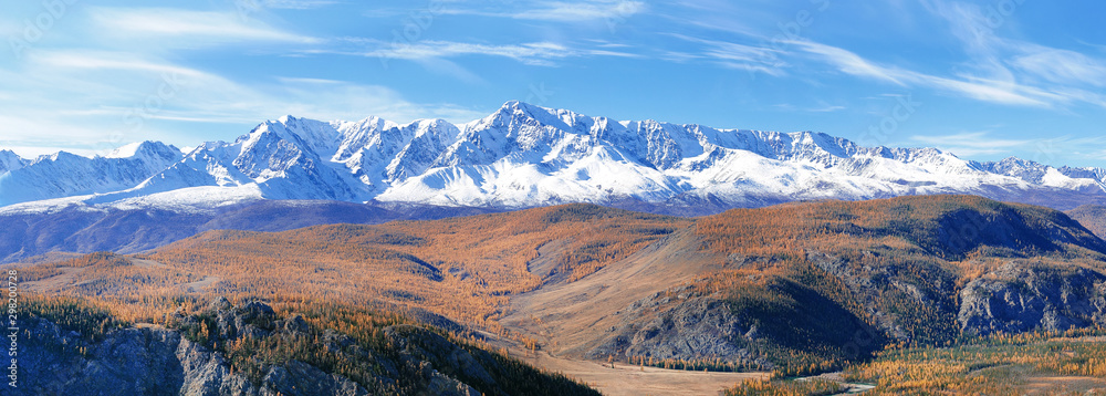 Panoramic view of the snowy mountains in autumn. Altai.