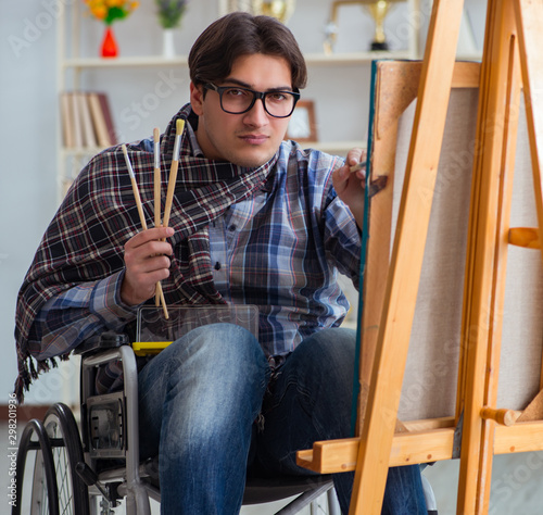 Disabled artist painting picture in studio