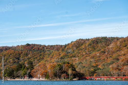 青空を背景に湖と紅葉した山／This lake is located on Mt. Akagi in Gunma Prefecture, Japan.