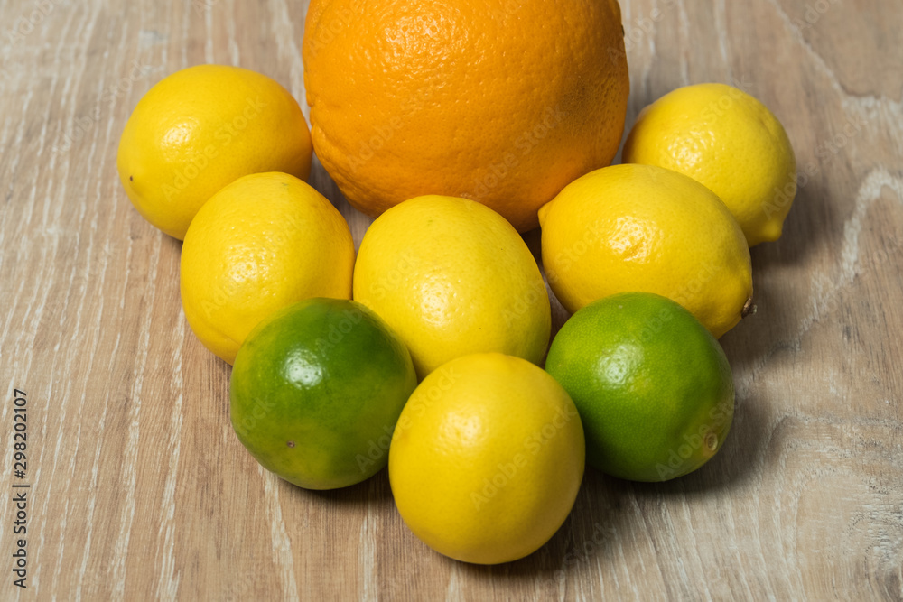 Set of citrus fruits. Orange, lemon and lime studio image. Lime with lemon and orange on a wooden background.