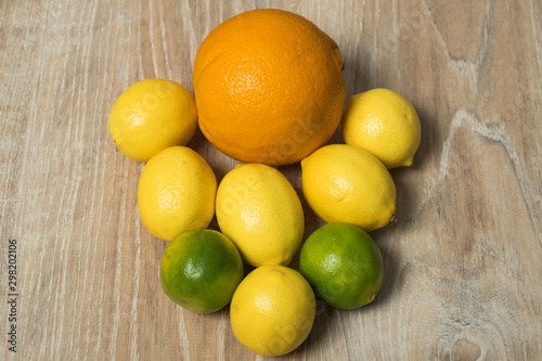 Set of citrus fruits. Orange  lemon and lime studio image. Lime with lemon and orange on a wooden background.