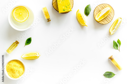 Lemon cosmetics. Cleansing tonic and handmade soap on white background top view frame copy space