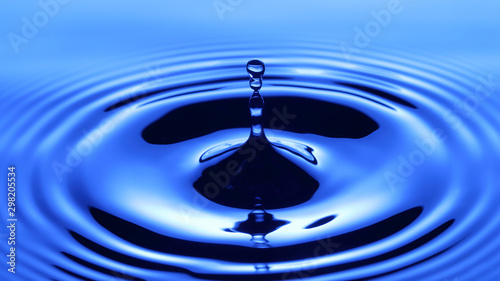 Splash of drop water in blue tone, blank spce from above to create concepttual.